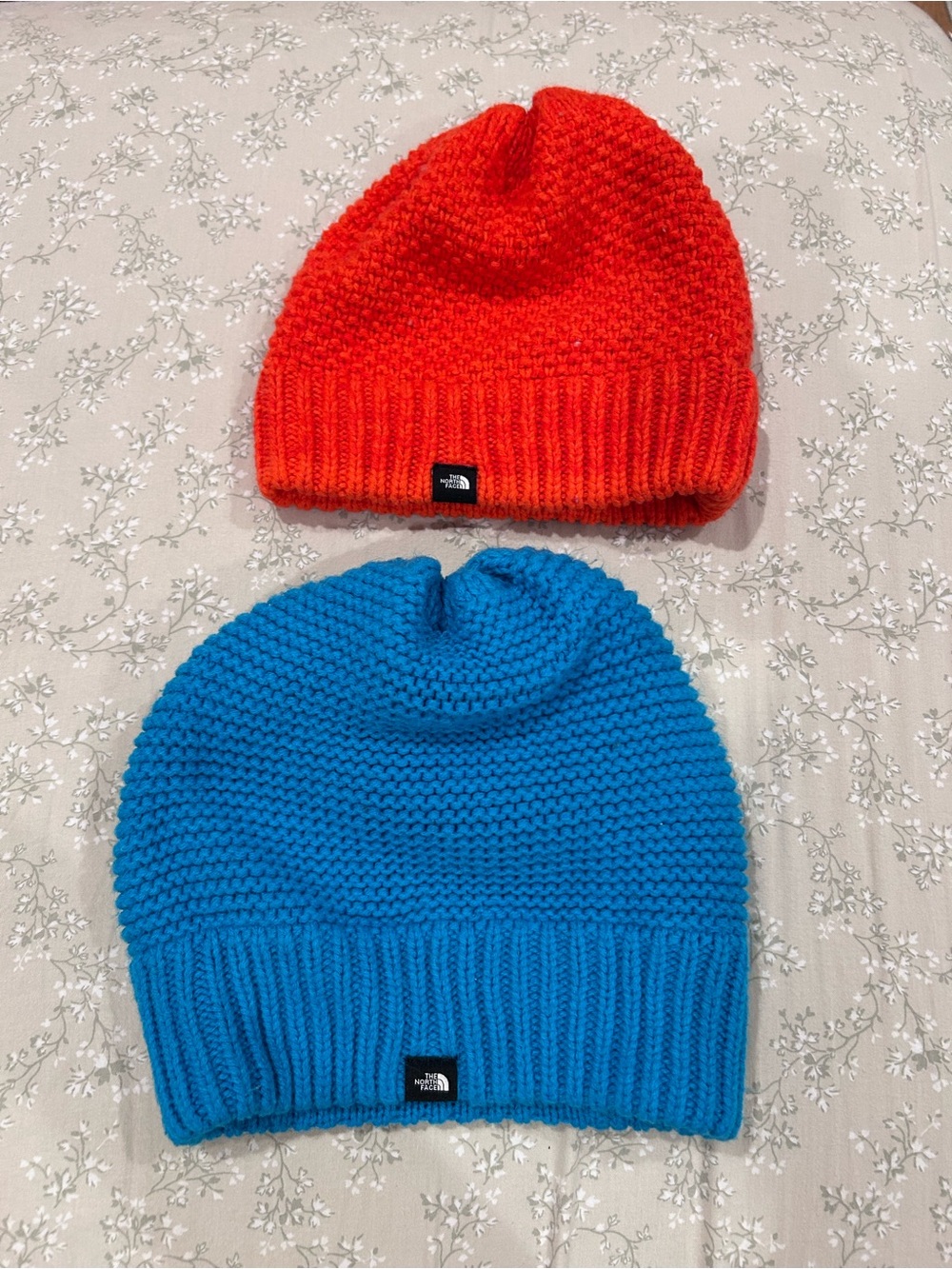 The North Face Knit Beanies in Bright Orange and Vibrant Blue